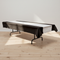 Folding table with black and silver cloth on a wood floor