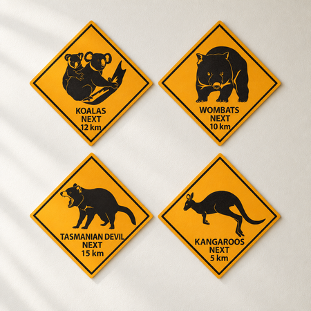 Four Australian wildlife road sign cut-outs on an off-white wall