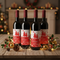 Four Christmas Wine Bottles on Festive Table