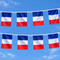 French cloth flag bunting hung outdoors against a blue sky, in square format