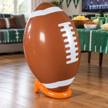 Giant 91cm inflatable American football and tee on a wood floor in a Super Bowl party setting