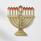 Gold and red menorah cardboard cut-out on a white wall