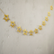 Gold Star Garland on Pale Neutral Wall