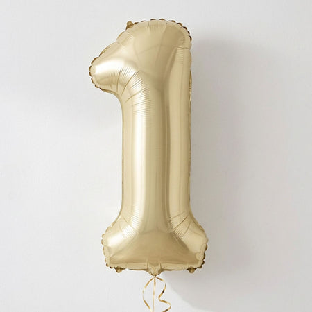 A metallic gold foil balloon shaped like the number one, floating against a plain light gray background.