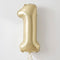 A metallic gold foil balloon shaped like the number one, floating against a plain light gray background.