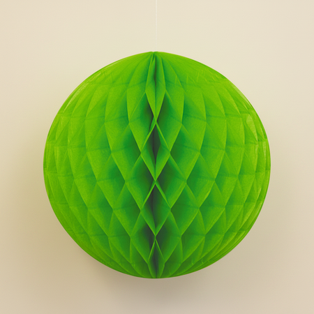 Green Honeycomb Ball Hanging Against Neutral Wall