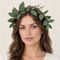 Green leafy head wreath worn close up against a neutral background, in square format