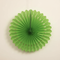 Green Tissue Fan Hanging Against Neutral Wall