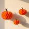 Hanging Pumpkin Paper Decorations on Cream Wall
