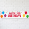 Happy 2nd Birthday banner on a white brick wall with soft light and shade, in square format
