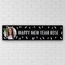 Happy New Year banner on a white brick wall