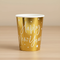 Happy New Year gold paper cup on a wood table