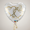 Heart-shaped balloon floating with gold curling ribbon against a neutral background in square format