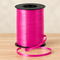 Hot pink curling ribbon spool close up on a wooden table with a neutral background, in square format