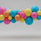 Colorful balloon arch on a plain background