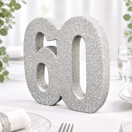 Close-up of a 20 cm silver glitter number 60 table decoration in an alcohol-free anniversary table setting