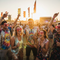 Diverse group at a music festival wearing hot pink heart-shaped novelty sunglasses