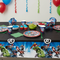 Marvel Avengers plastic tablecloth styled on a superhero birthday party table with matching tableware