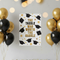 The Tassle Was Worth The Hassle graduation poster unframed, pinned to a wall in A3 portrait proportions with gold and black balloon decorations