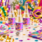 Carnival personalised miniature champagne bottle soap bubbles on a colourful party table with bubble wand and floating bubbles