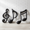 Inflatable Musical Notes Against White Brick Wall