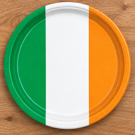 Irish tricolour plate close-up from above on a wood table, in square format