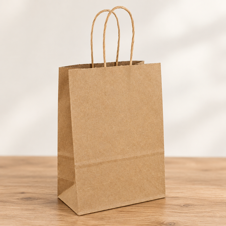 Kraft gift bag close up on a wood table with a neutral background, in square format