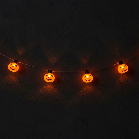 LED Pumpkin String Lights Glowing Against Dark Wall Halloween