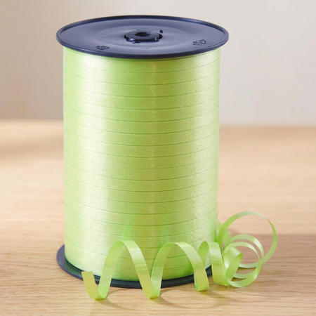 Lime green curling ribbon reel on the matching wooden tabletop with a neutral background and soft lighting, in square format