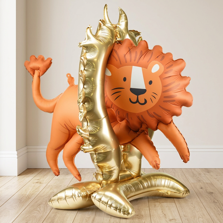Lion balloon display standing on a wood floor against a neutral wall, close up in square format
