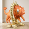 Lion balloon display standing on a wood floor against a neutral wall, close up in square format