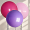 Magenta, pink and purple balloons on neutral background