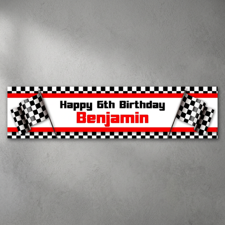 Motor racing birthday banner on a slightly rough grey wall with soft light and shade, in square format