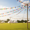Multicoloured Bunting Strung High at Summer Fete Field