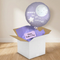 Mummy moon-and-stars balloon and gift box on a wooden floor against a softly lit neutral wall, in square format