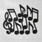 Musical Note Cut-Outs on White Brick Wall