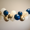 Navy, gold, and white balloon garland with plain background