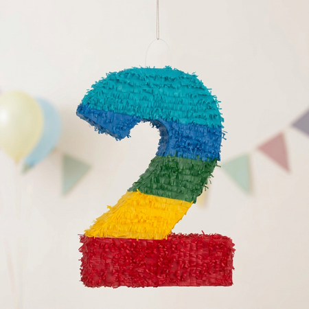 Number 2 piñata standing out against a softer, muted party background in square format