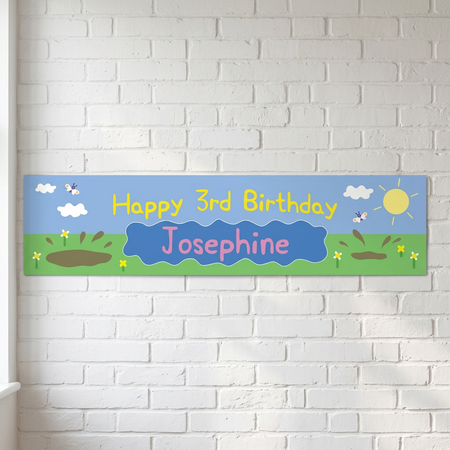Personalised birthday banner on a white brick wall with soft light and shade, in square format