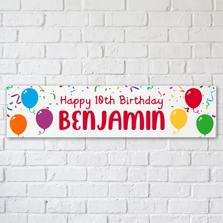 Personalised birthday banner on a white brick wall with soft light and shade, in square format