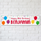 Personalised birthday banner on a white brick wall with soft light and shade, in square format