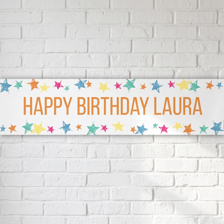 Personalised Happy Birthday Laura banner on a white brick wall with soft light and shade, in square format