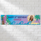 Personalised tropical birthday banner on a white brick wall with soft light and shade, in square format