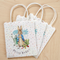 Peter Rabbit party bags on a wood background, keeping the original arrangement and perspective in square format