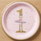 Pink and gold ballerina first birthday plate on a wood tabletop, shown close up from above in square format