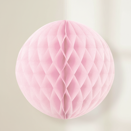 Pink Honeycomb Ball Hanging Against Neutral Wall