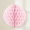 Pink Honeycomb Ball Hanging Against Neutral Wall