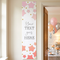 Pink ombre stars banner on a cream wall beside an open doorway into a pink, peach and silver celebration, in square format