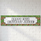 Pixel-style birthday banner on a white brick wall with soft light and shade, in square format
