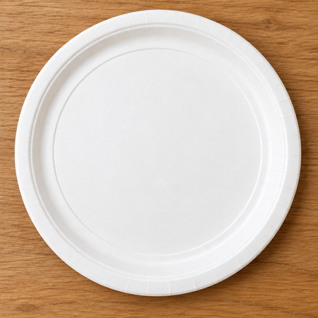 Plain white paper plate on a wood table
